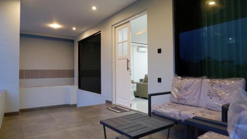 a living room with a table and a large window at Villa Dalia Puncak Na5-06 in Cikundul