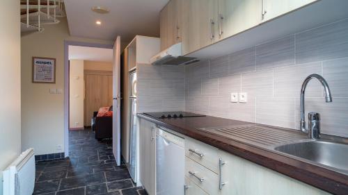 a kitchen with a sink and a counter top at Sud Ocean L N94 2P4 in Guidel