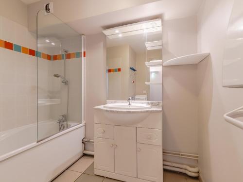 a white bathroom with a sink and a shower at L Ocean N08 3P5 in La Tranche-sur-Mer