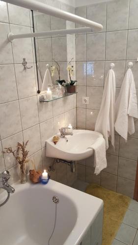 a white bathroom with a sink and a bath tub at Apartment Ana in Kali