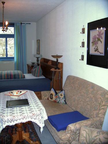 a living room with a couch and a table at Alter Ackerbuergerhof in Bad Frankenhausen