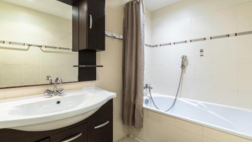a bathroom with a sink and a bath tub at Lisa Maria D N38 2P5 in Sari Solenzara