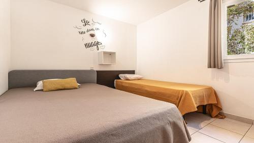 two beds sitting next to each other in a room at Lisa Maria D N38 2P5 in Sari Solenzara