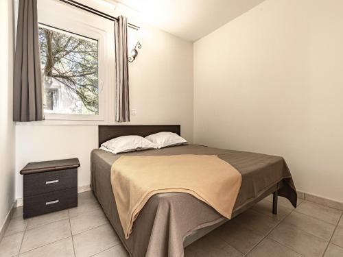 a bedroom with a bed and a window at Lisa Maria E N60 3P7 in Sari Solenzara