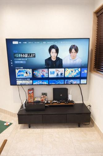 a television screen with a computer on a wall at 金春 -in KONPAL Penthouse- in Kikuyo