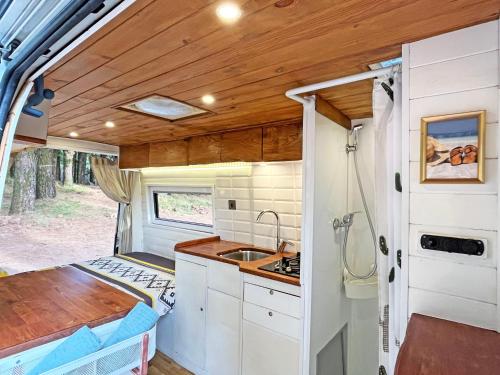 a kitchen in an rv with a sink at Tenerife Stylish Camper Van with Bathroom in Arona