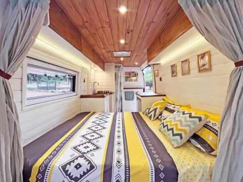 a bedroom with a bed in a tiny house at Tenerife Stylish Camper Van with Bathroom in Arona