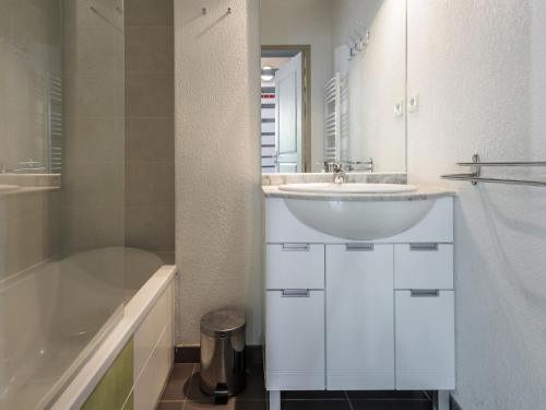 a white bathroom with a sink and a shower at D du Ventoux D N55 3P6 in Aubignan
