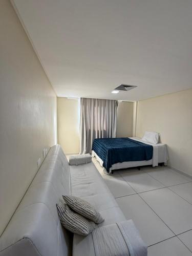 a living room with a bed and a couch at Imperial Flat orla de tambáu in João Pessoa