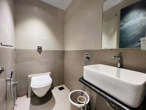 a bathroom with a sink and a toilet at Hotel Imperial Suite-Near BKC in Mumbai
