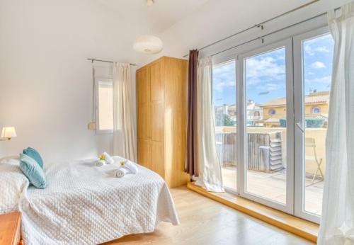 a bedroom with a bed and a large window at Ideal Property Mallorca - Villa Feel Good in Alcudia