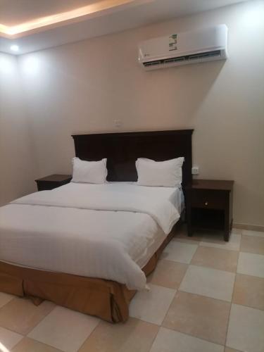 En eller flere senge i et værelse på شقق مزون للشقق المخدومة