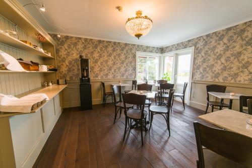 a restaurant with tables and chairs and a chandelier at Hotell Stensborg in Skellefteå