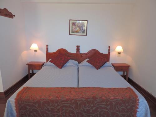 a bedroom with a large bed with two night stands at Casa Rural Los Helechos in Agulo