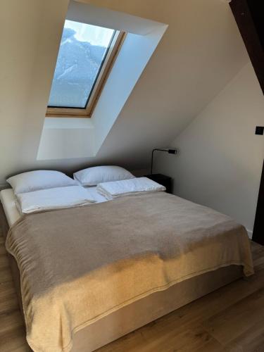 Giường trong phòng chung tại Apartamenty Fuleda nad jeziorem Dobskim Mazury Holiday