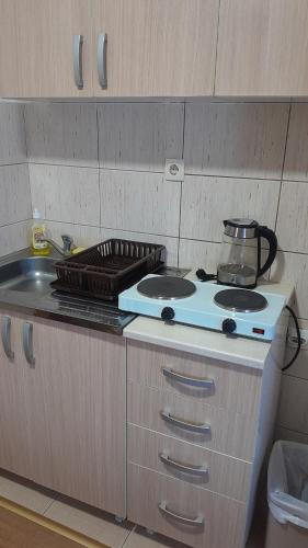 a kitchen with a stove top and a sink at Apartmani Aleksijević in Zlatibor