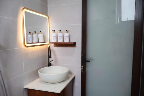 a bathroom with a bowl sink and a mirror at GAJOs HOUSE in Thanh Xuân
