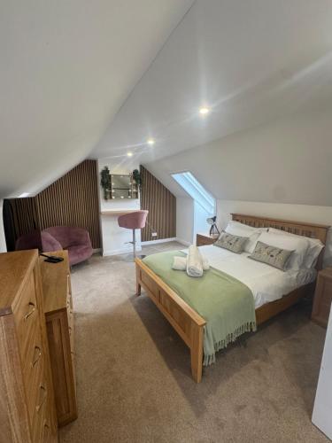 a bedroom with a large bed and a window at Arthur's View in Dalkeith