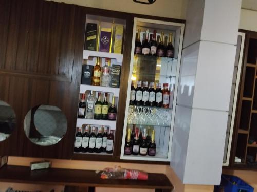 a cabinet filled with lots of bottles of alcohol at 6A Resort in Owerri