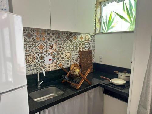 a kitchen with a sink and a counter top at Vila em Laranjeiras in Rio de Janeiro