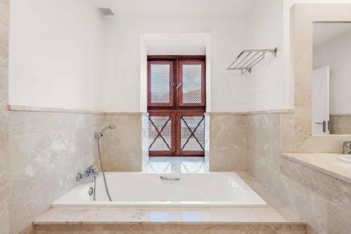 a bath tub in a bathroom with a red door at Villa Oceana in Manilva