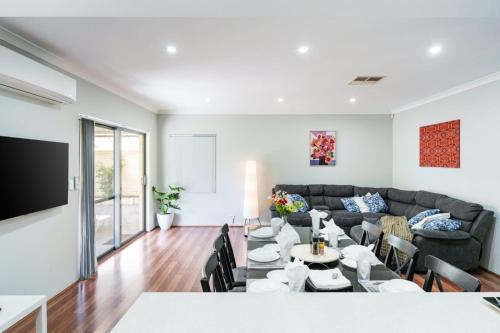 a living room with a couch and a table at Queens Residence Perth Western Australia in Perth