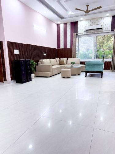 a large living room with a couch and a table at Mango People Farm in Gurgaon