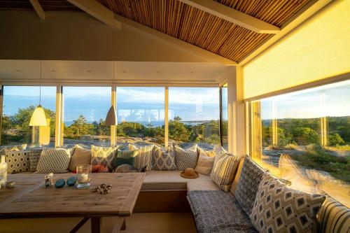 a living room with a couch and a table at Architectural Gem Between Risør And Kragerø in Søndeled