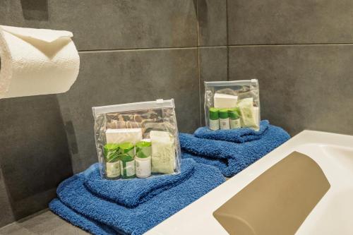 a bathroom with two containers of soap and a sink at City Centre 2-Bed, 2 Balconies, 65 Inch TV, Free Parking, Coffee Machine, Netflix in Leicester