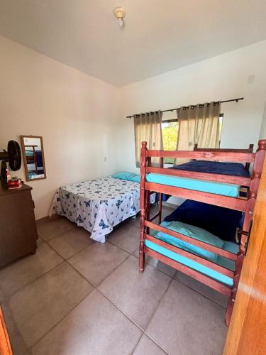 a bedroom with two bunk beds in a room at Rancho Bela Vista in Alexânia