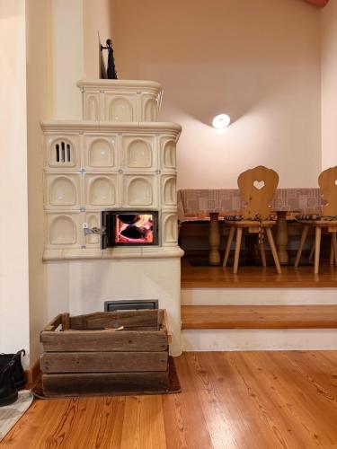 a living room with a fireplace and a table at Cèsa Emily in Campitello di Fassa