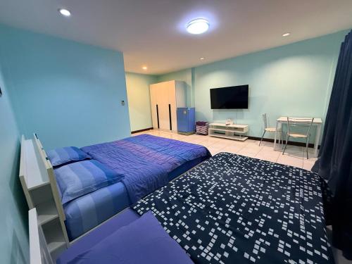 a bedroom with a bed and a flat screen tv at Best Rent a Room in Nai Yang Beach