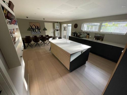 a kitchen and living room with a table and chairs at Skovbrynets guesthouse in Herning