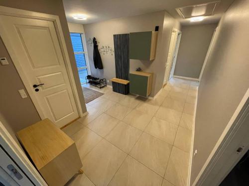 an empty hallway with a door and a tile floor at Skovbrynets guesthouse in Herning