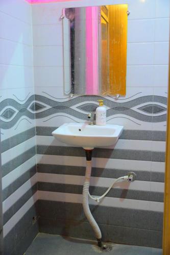a bathroom with a sink and a mirror at Mahakal homestay in Ayodhya