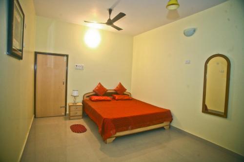 a bedroom with a bed and a ceiling fan at Sheetal Homestay in Varanasi
