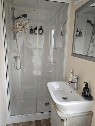 a bathroom with a shower and a sink at 205 Holiday Resort Unity 6 berth No Pets Passes Optional in Brean