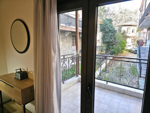 a room with a door open to a balcony at 2Steps to the Lake in Kastoria