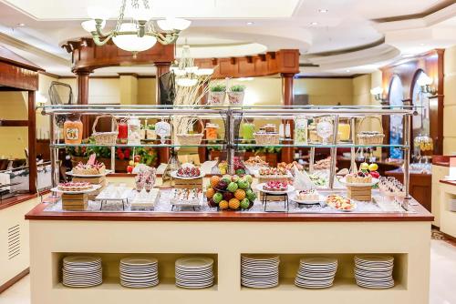 a buffet in a restaurant with plates and food at Knight Castle Hotel - Formerly known as Carlton Palace Hotel in Dubai