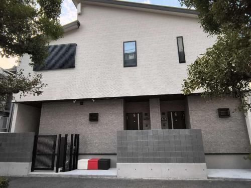 a building with doors and a fence in front of it at 北滨Grace DAY 101 in Takamatsu