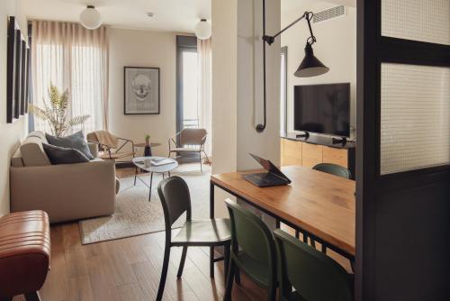 a living room with a table and chairs at Líbere Madrid Malasaña in Madrid