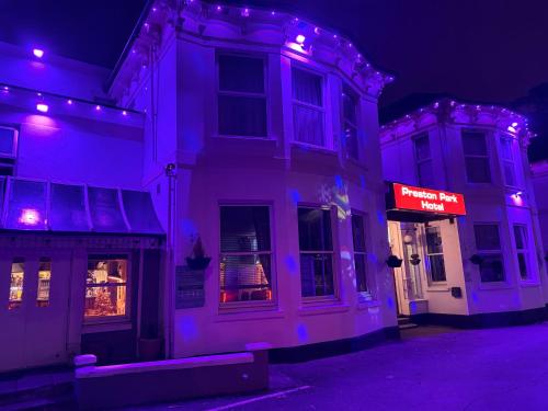 a white building with purple lights on a street at Preston Park Hotel in Brighton & Hove