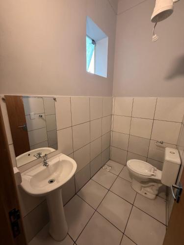 a bathroom with a sink and a toilet at Cerrado Hostel in Goiânia
