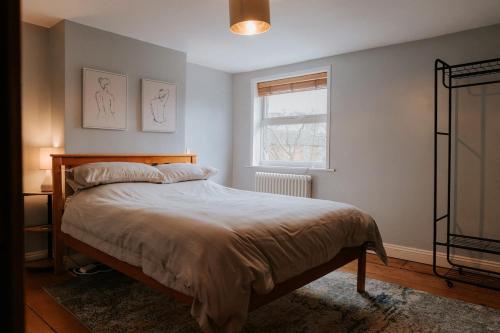 a bedroom with a bed and a window at River Cottage in Beccles
