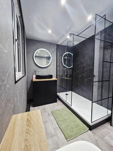 a bathroom with a shower with a sink and a mirror at Sea View House Marske-by-the-Sea - Coastal Stay - Pet Friendly in Marske-by-the-Sea