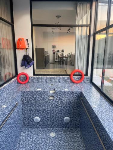 a large blue bath tub in a room with windows at شاليهات ريف الوادي in Taif