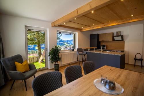 a kitchen and living room with a table and chairs at Apartment Waldfrieden in Pfons