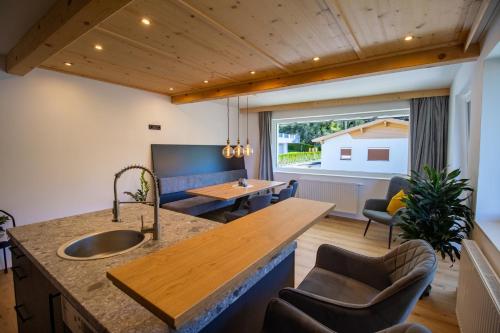 a kitchen and living room with a large window at Apartement Waldfrieden in Pfons