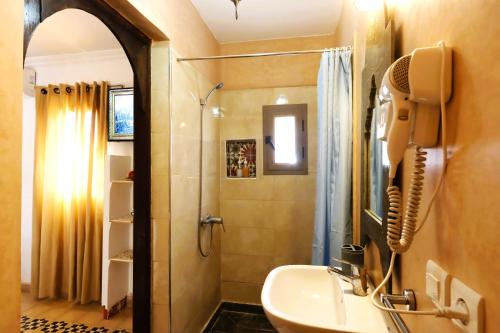 a bathroom with a shower and a sink at Riad Makech in Marrakesh