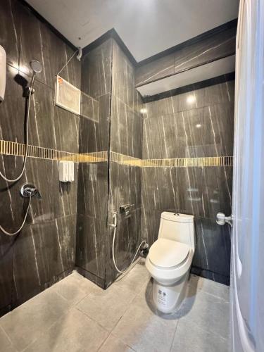 a bathroom with a toilet and a shower at SVAH Boutique Patong in Patong Beach